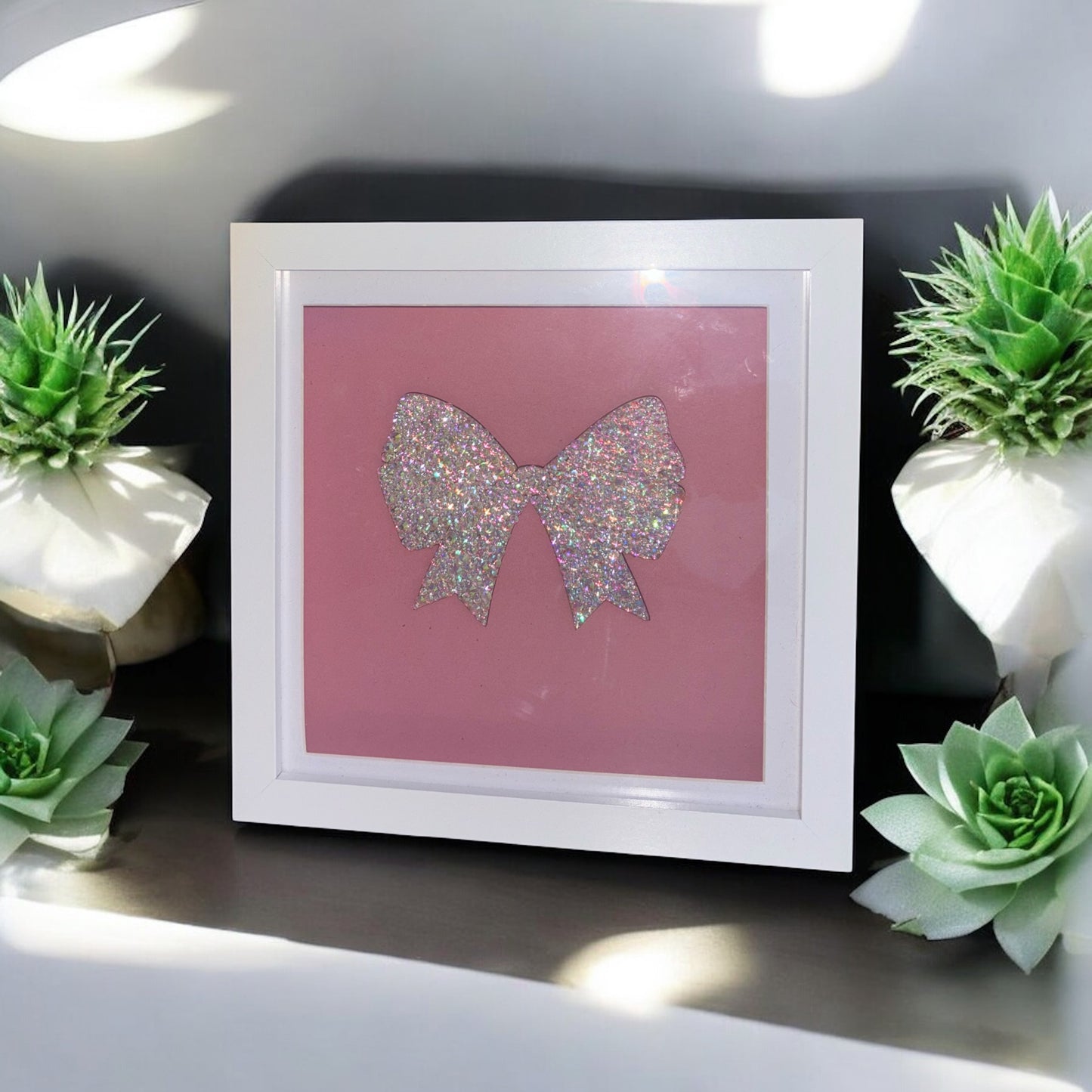 Wooden bow in box frame.